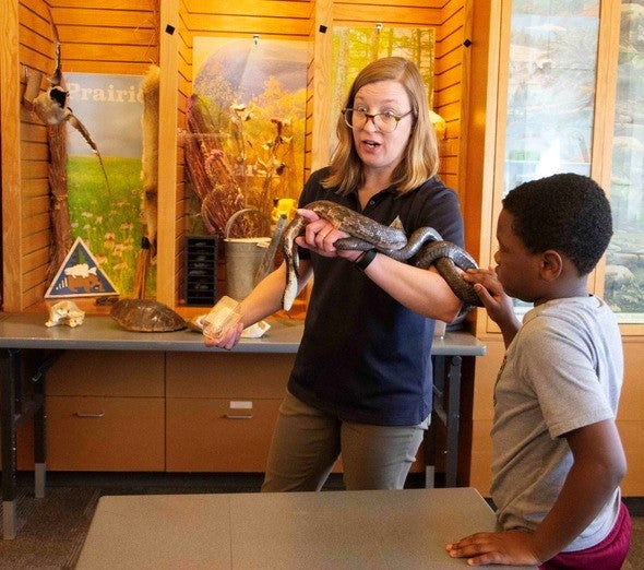 MDC naturalist shows snake to fourth graders
