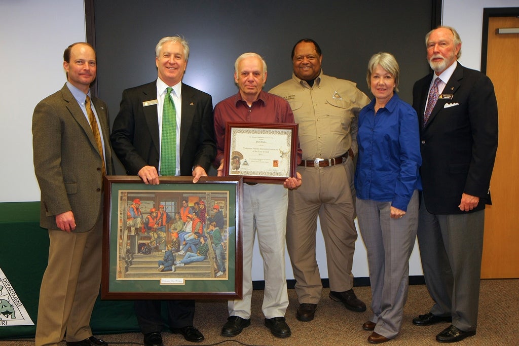 Hunter Ed winner Floyd Bohler with director and commissioners 