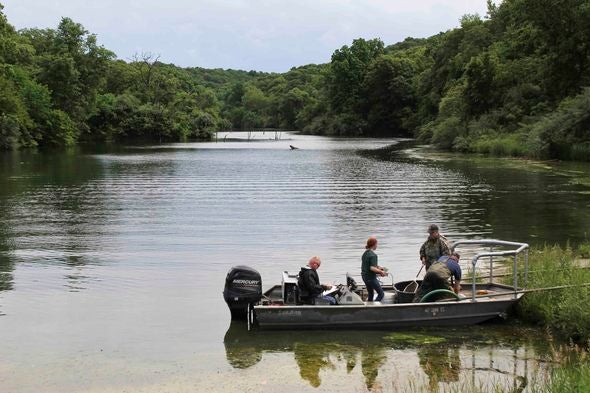 A group of anglers prepare to take their boat on Charity Lake