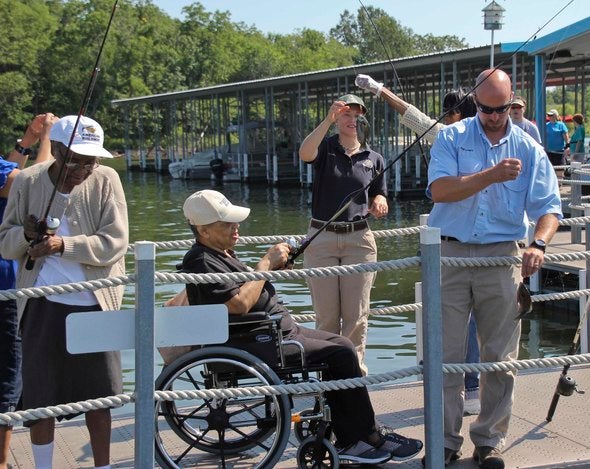 MDC staff helping special needs people fish.