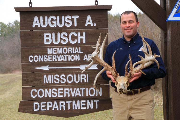 John Vogel holds the near-record non-typical deer skull rack 