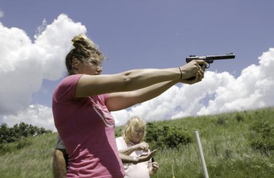 Woman aiming handgun