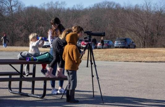 Kids use spotting scope during Eagle Days event at Smithville Lake