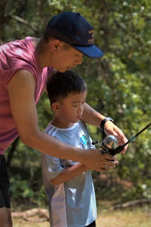 helping kid fish