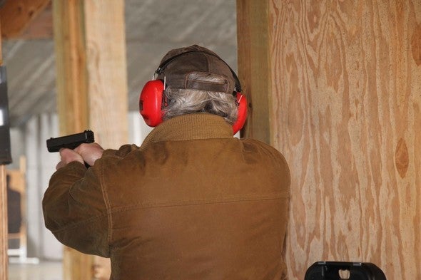 man shooting handgun