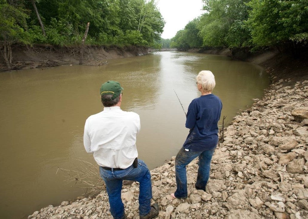 Couple fishing from stream