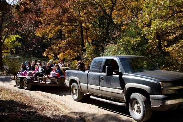 A truck pulls a trailer of people for a fall color tour of Poosey Conservation Area.