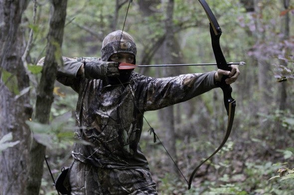 Archery hunter in woods