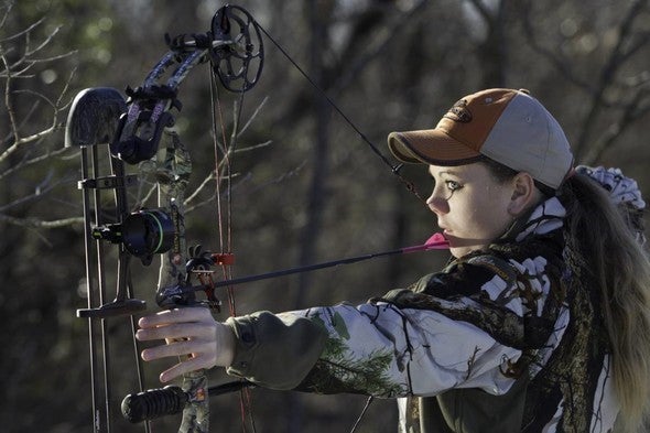 woman using crossbow