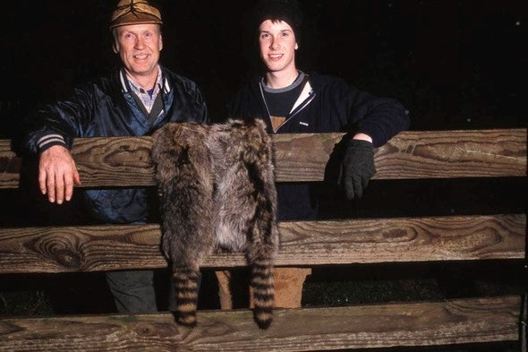 two raccoon hunters with pelts