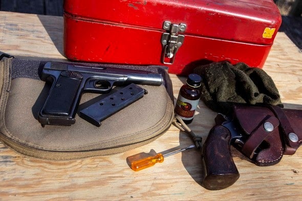 Handgun with cleaning supplies