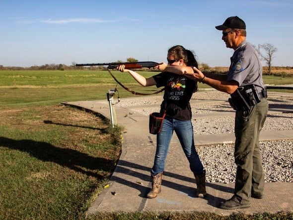 Agent giving trap shooting instruction