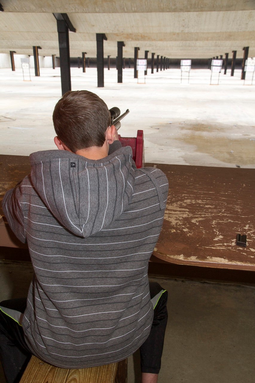 person shooting rifle at range