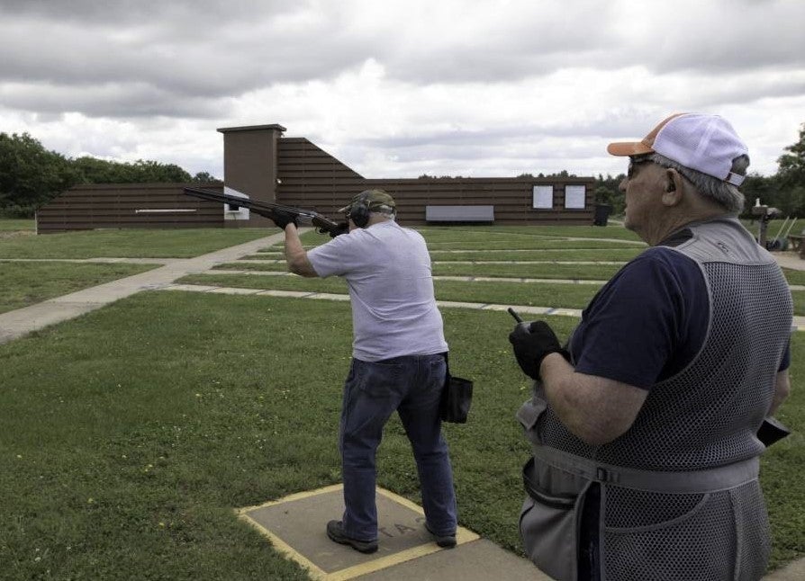 man shooting shotgun