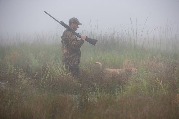 Waterfowl hunter with dog