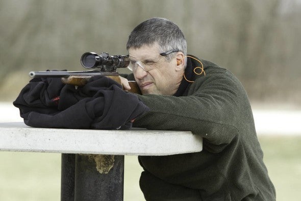 man shooting rifle