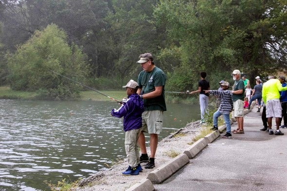 MDC staff help boy fish