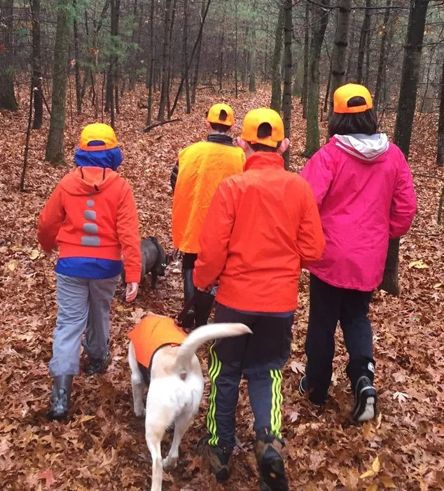 family hiking in hunter orange