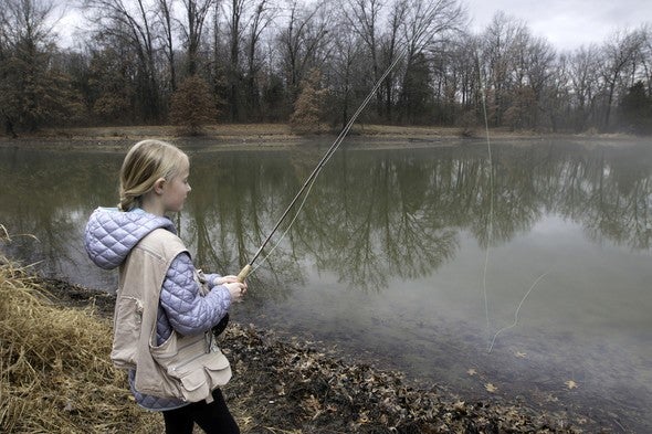 Girl trout fishing at lake