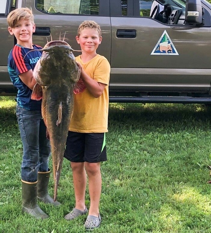 two kids with catfish