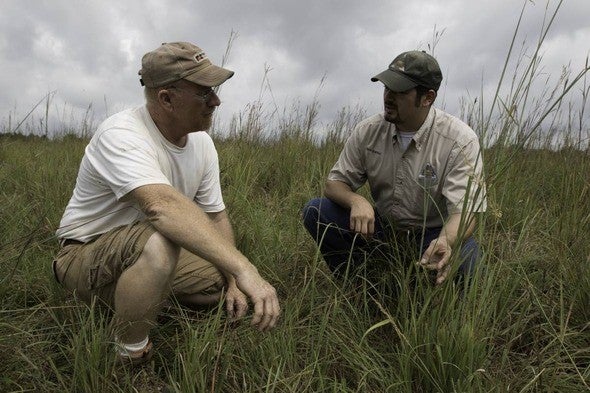 MDC staff member speaks with landowner in field
