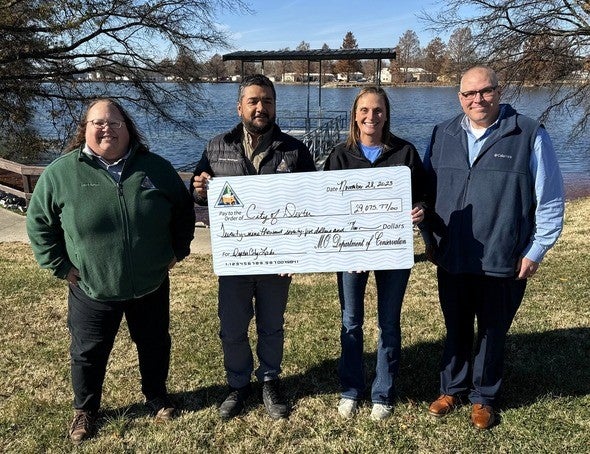 City of Dexter officials with MDC staff holding check for conservation grant partnership
