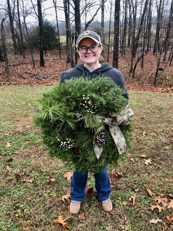 Girl holds holiday wreath