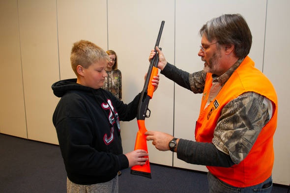 MDC volunteer teaches firearm safety to teenage boy