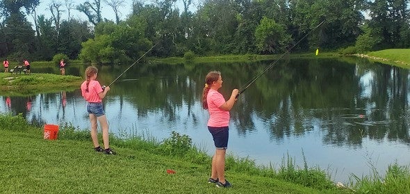 Girls fishing at girls nature camp