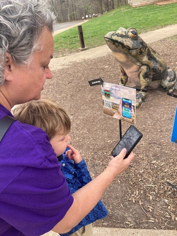 Grandmother and grandson playing Agents of Discovery game at MDC nature center