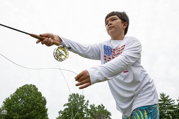Boy casting fishing line