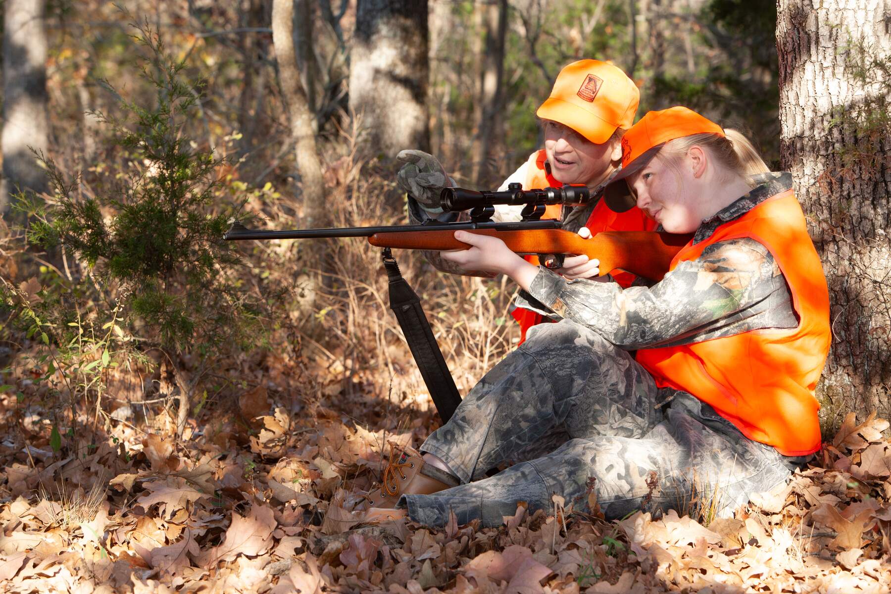 Mentor helps teenager with rifle while deer hunting