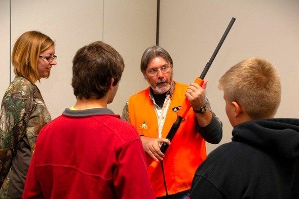MDC volunteer teaches firearm safety to hunter education students.