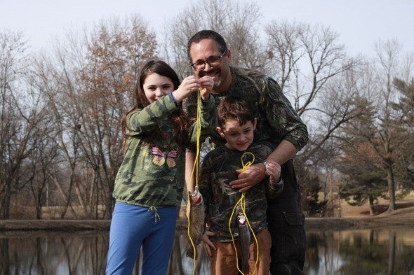 Dad and kids with trout