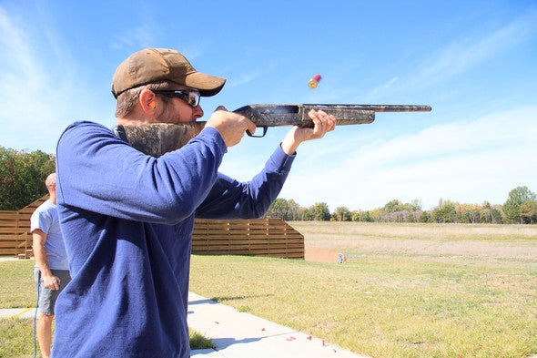 a man shoots with a shotgun