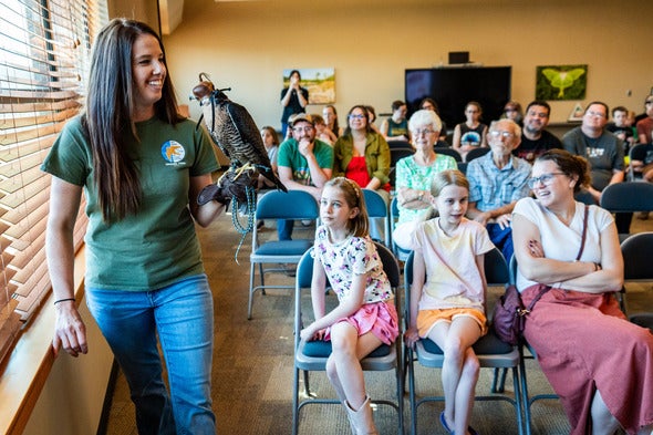 falcon and handler in classroom with kids