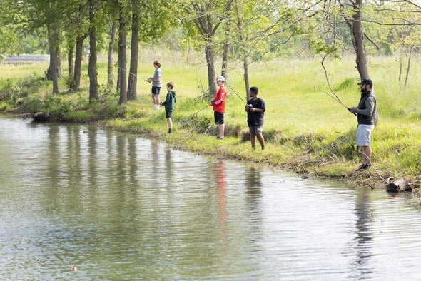 People fishing the pond at Boone County Nature School