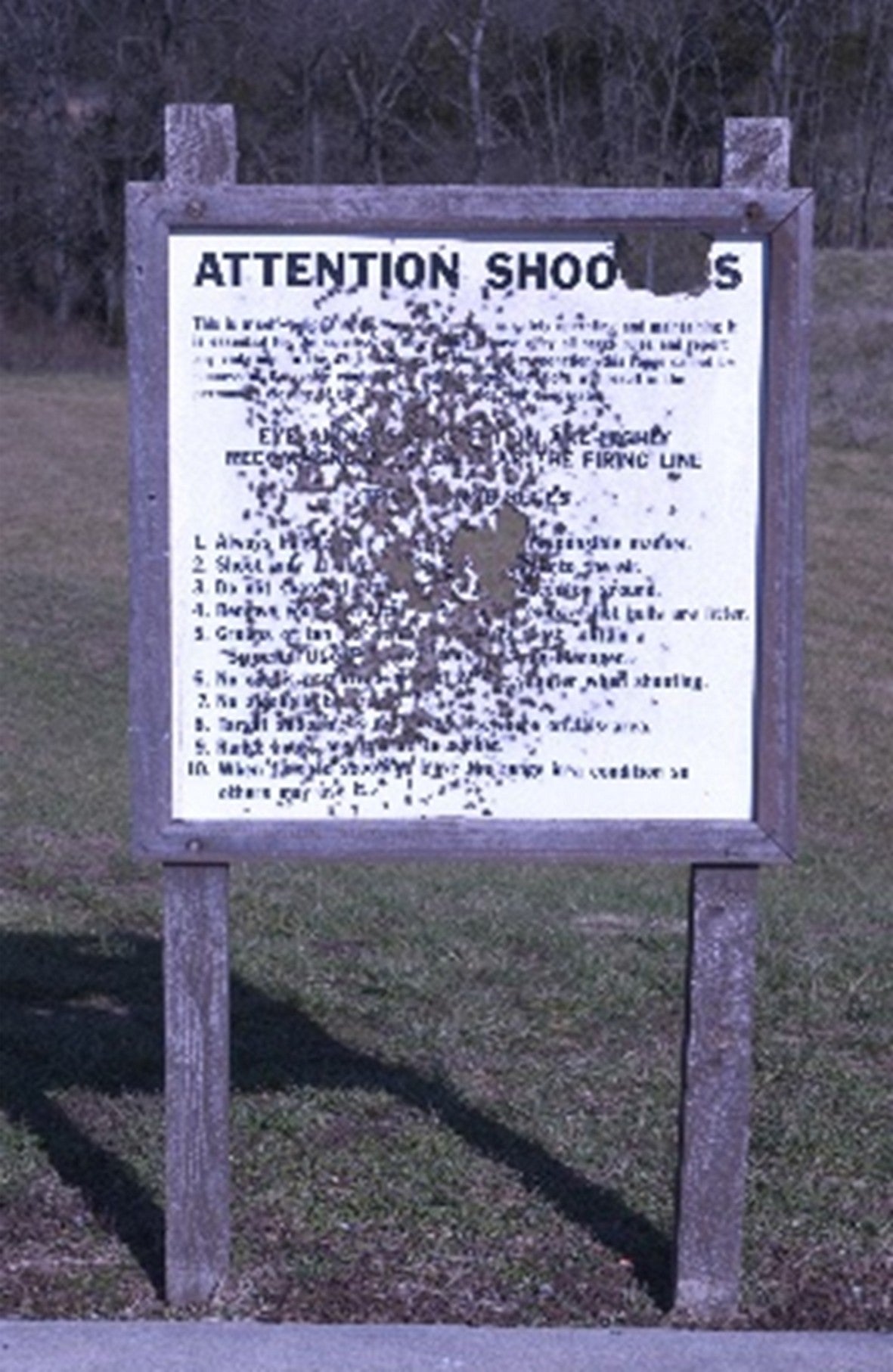 damaged shooting range sign