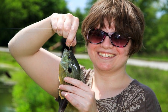 woman holding small fish