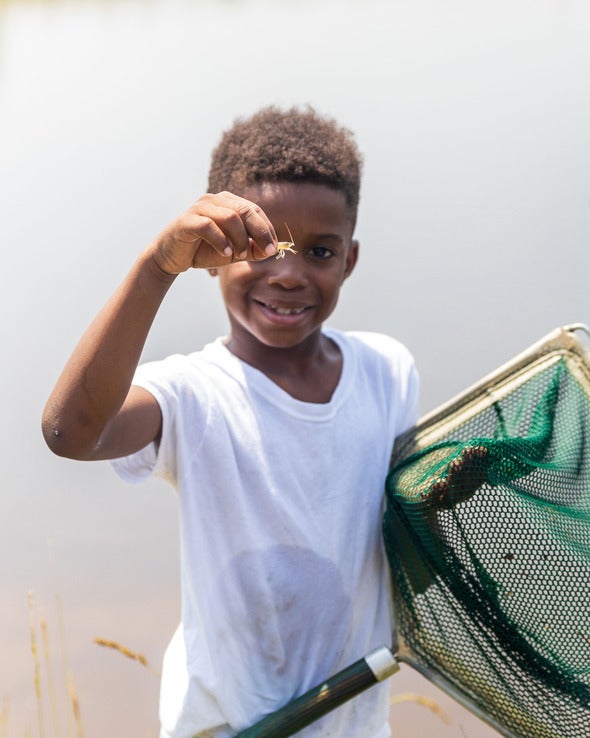 boy holding crawfish