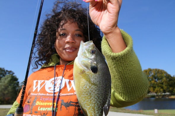 woman holding caught fish