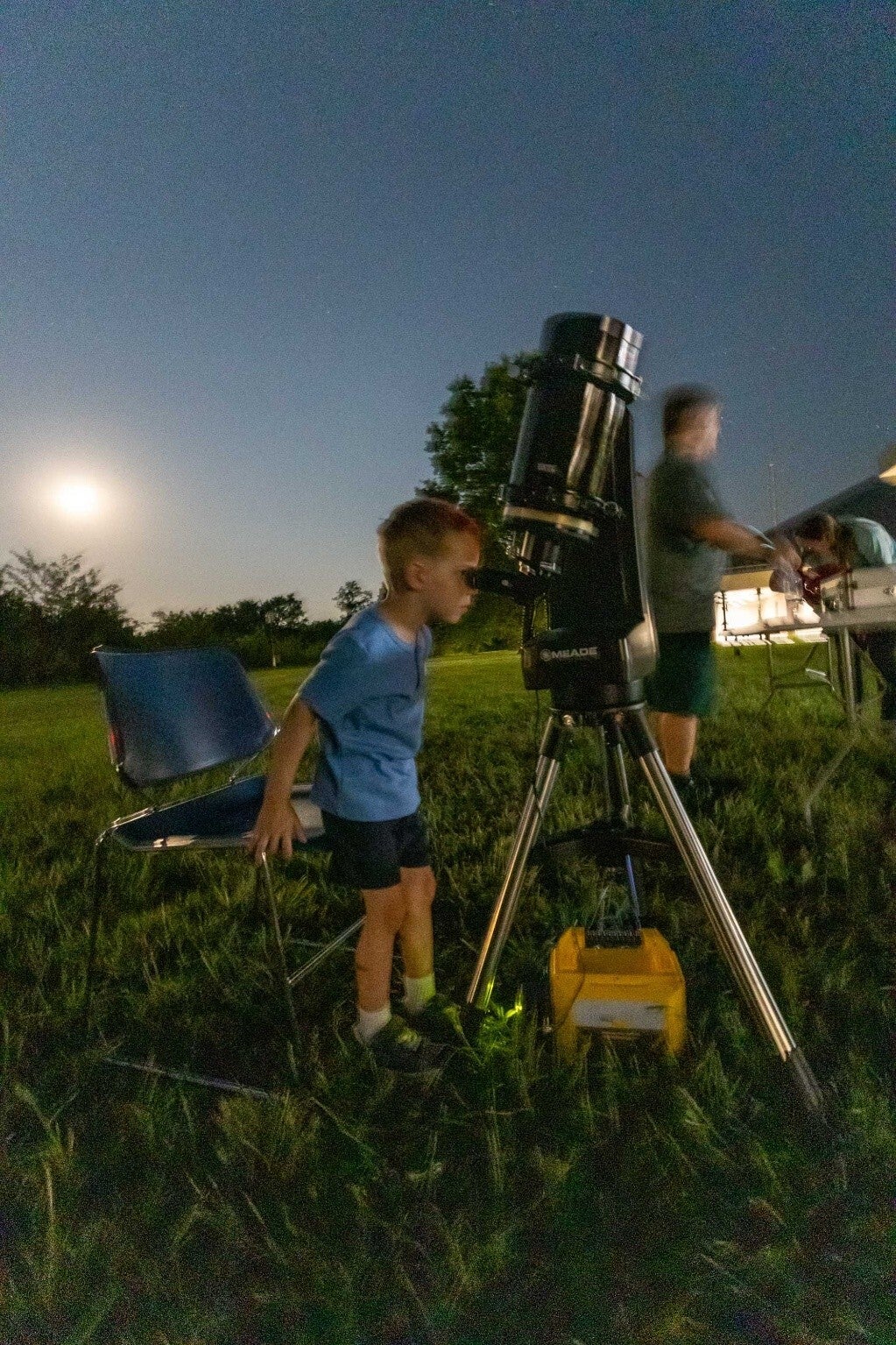 boy looking through telescope