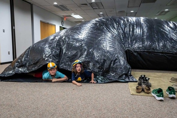 two kids in inflatable cave