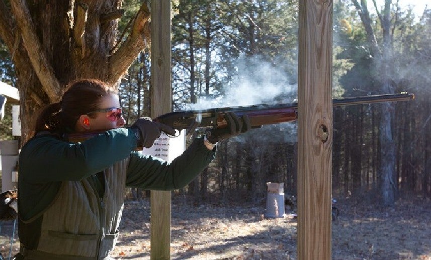 woman shooting shotgun