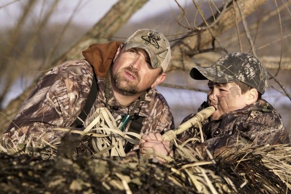 man and boy duck hunting 