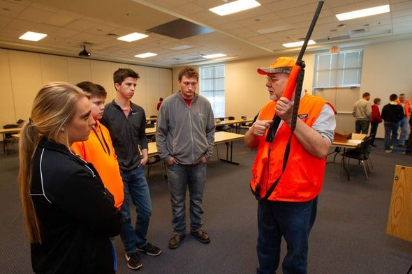 man teaches hunter education to students