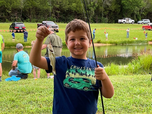 kid holding caught fish
