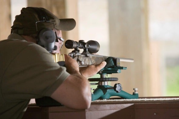 man sights-in firearm