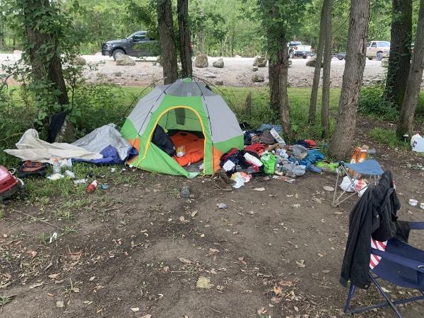 trashed and abandoned campsite on MDC area