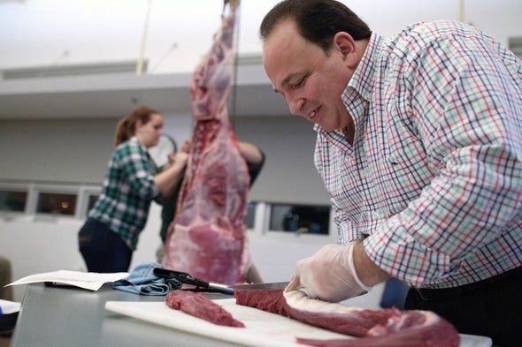 A man processes deer meet